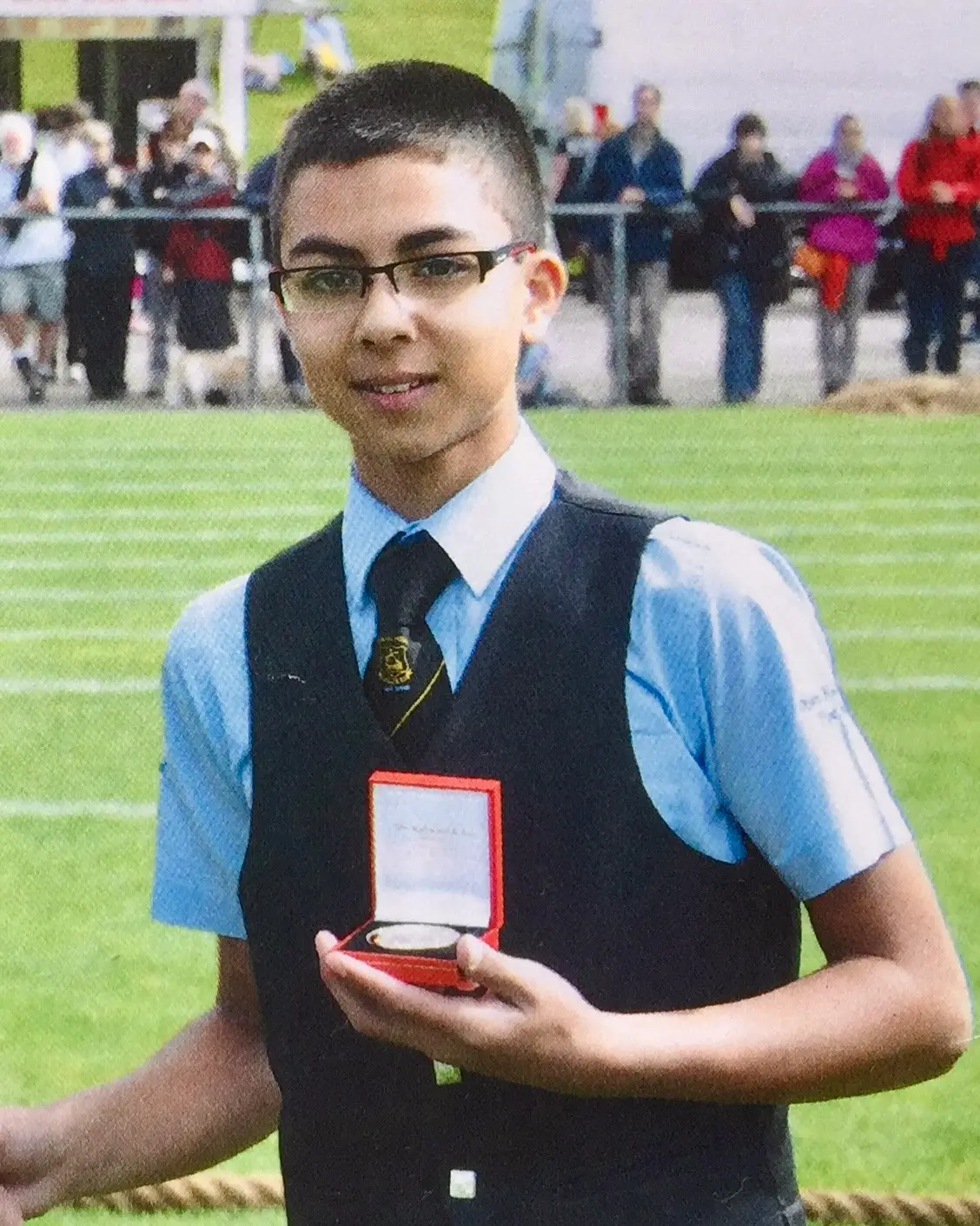 Aaron McInnes as a young piper holding a medal on the competition field