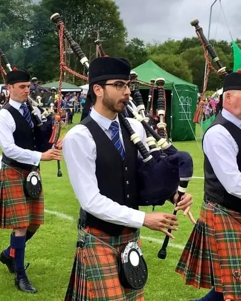Aaron McInnes marching with Oban Pipe Band